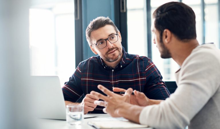 Shot of two businessmen having a discussion in an office
